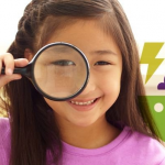 Girl looking through magnifying glass